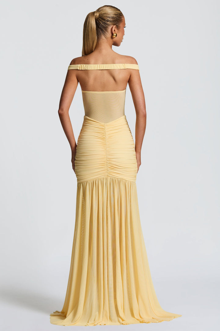 Back view of pale yellow off-shoulder ruched maxi dress with flowing skirt