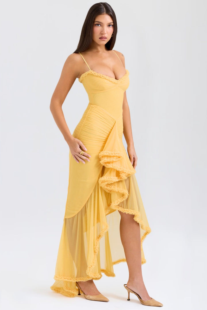 Side view of yellow maxi dress showing ruched bodice and ruffled trim