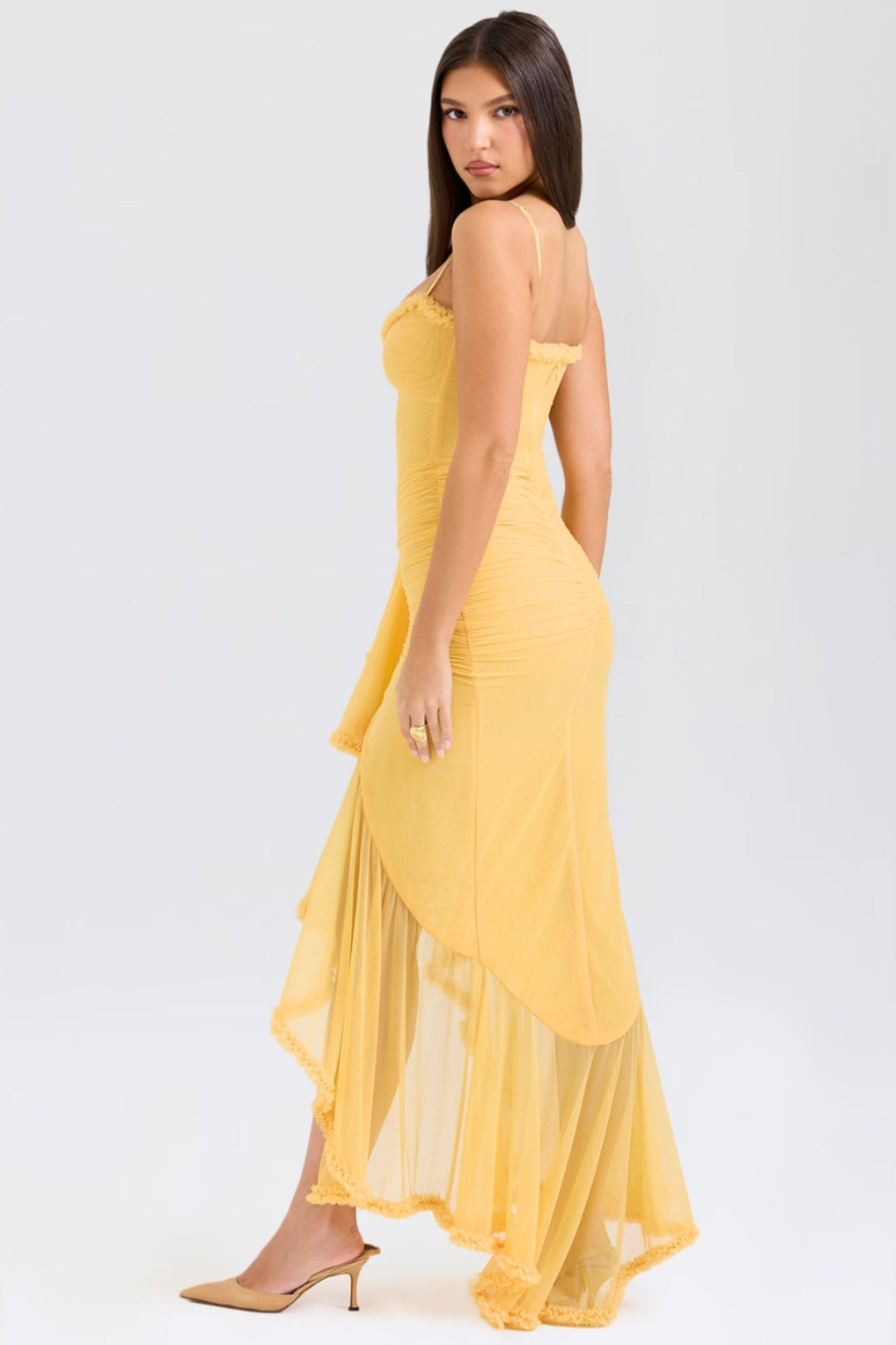 Back view of yellow spaghetti strap maxi dress with flowing ruffled skirt