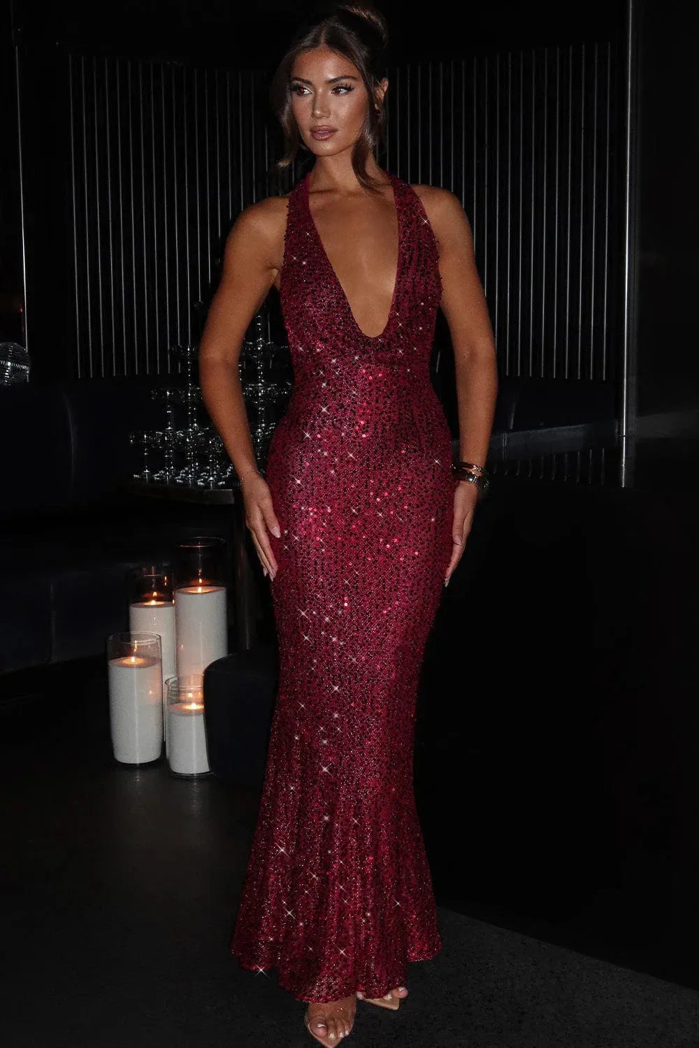 Burgundy sequin halter maxi dress with deep V-neckline and floor-length fit