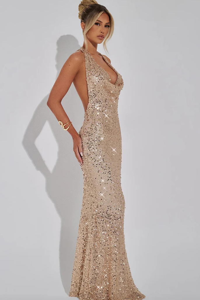 Champagne sequin halter maxi dress side profile with flowing skirt