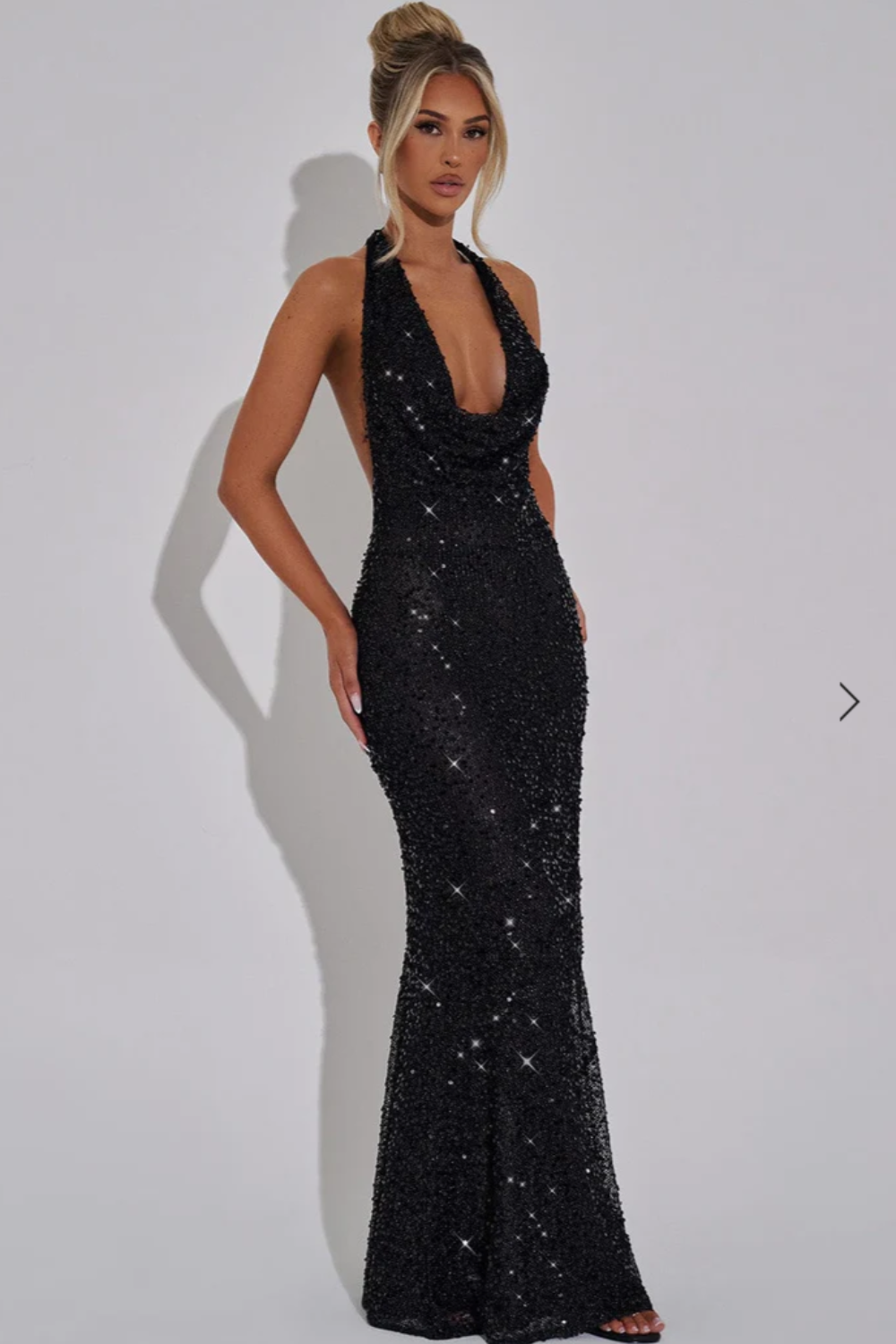 Black sequin halter maxi dress with plunging neckline and fitted silhouette