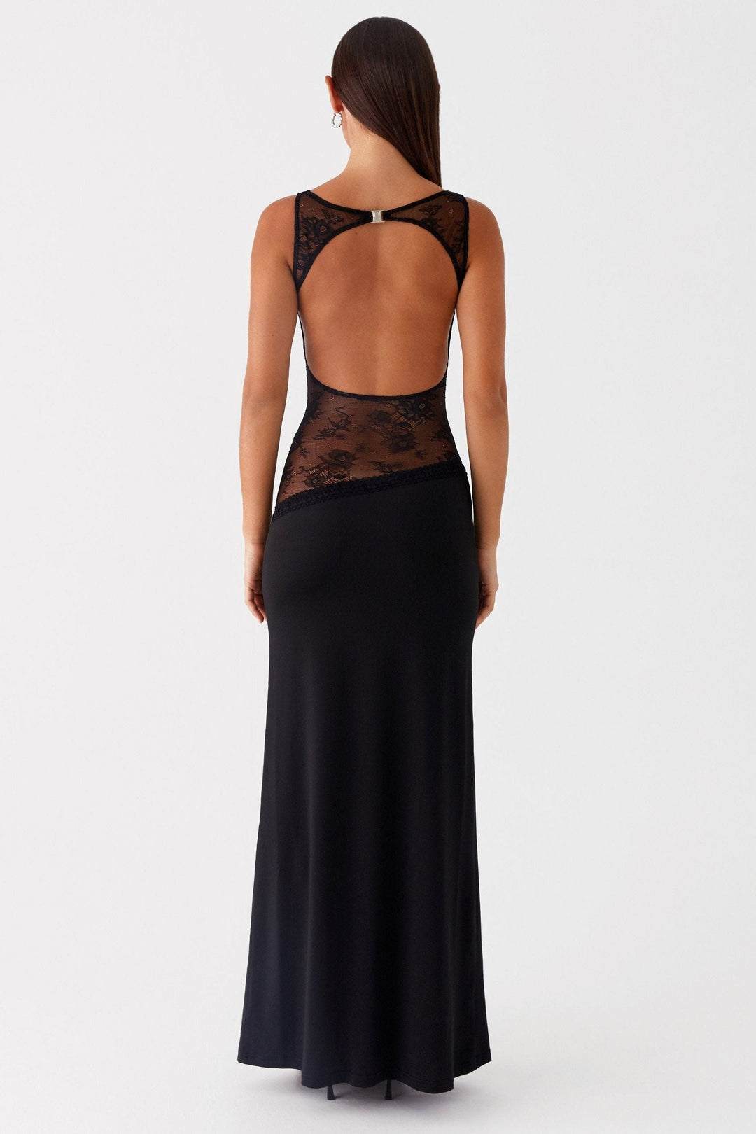 Back view of black maxi dress featuring open lace waist and cross-back straps