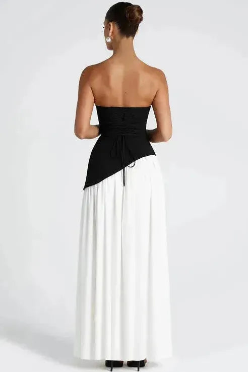 Back view of black and white strapless maxi dress with high slit and open back