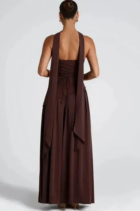 Back view of burgundy strapless maxi dress showing open back and flowing high slit