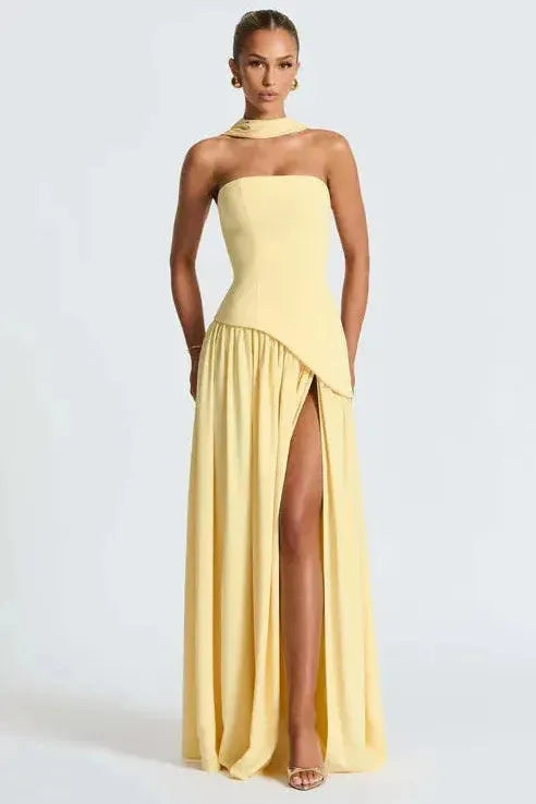 Pale yellow strapless maxi dress with asymmetrical high slit and draped skirt