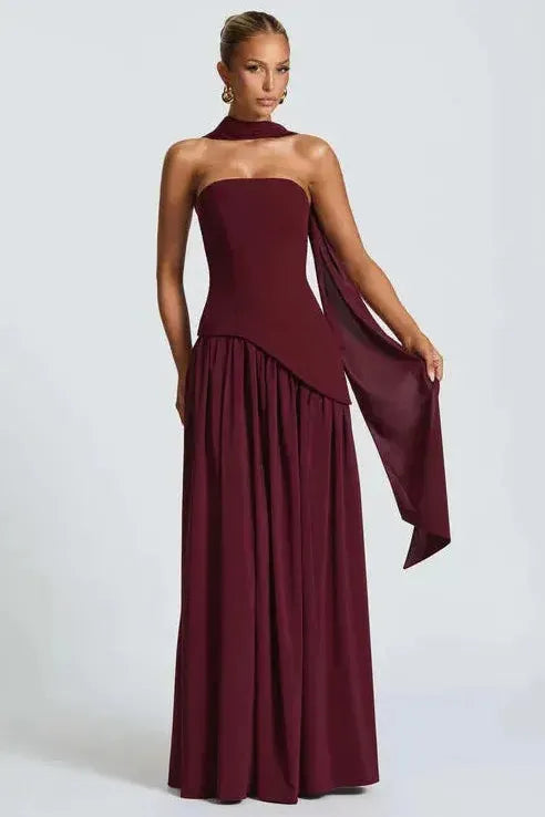 Burgundy strapless maxi dress with high slit and flowing draped fabric detail