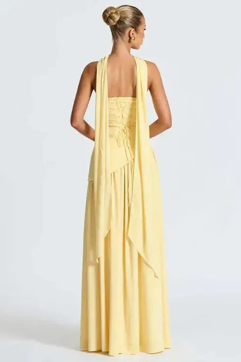 Back view of yellow strapless maxi dress with open back and high leg slit