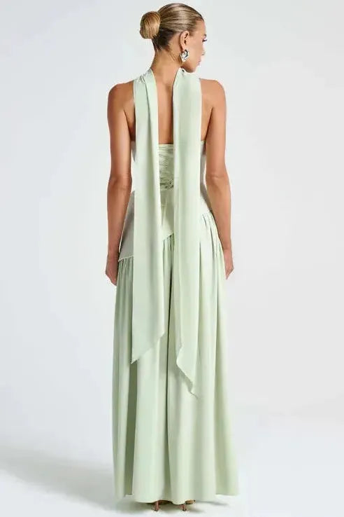 Back view of sage green strapless maxi dress with open back and high slit