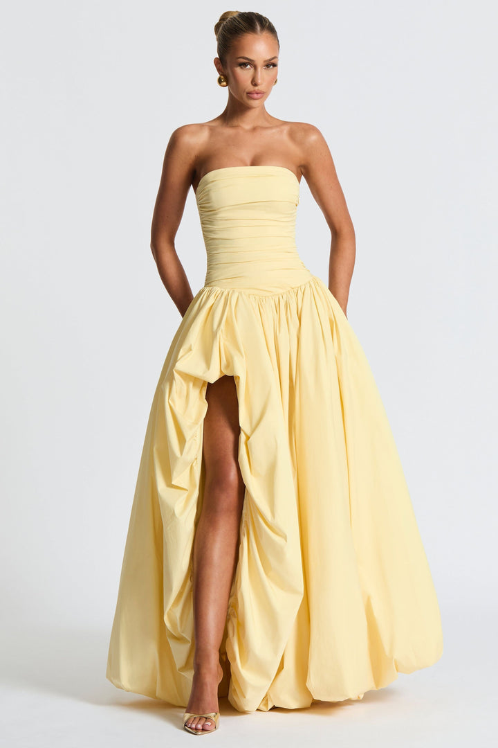 Front view strapless yellow dress with ruched bodice and asymmetrical hemline