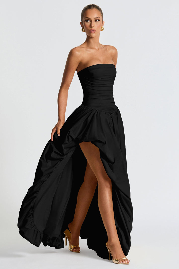 Black strapless high-low maxi dress with ruched bodice and flowing skirt