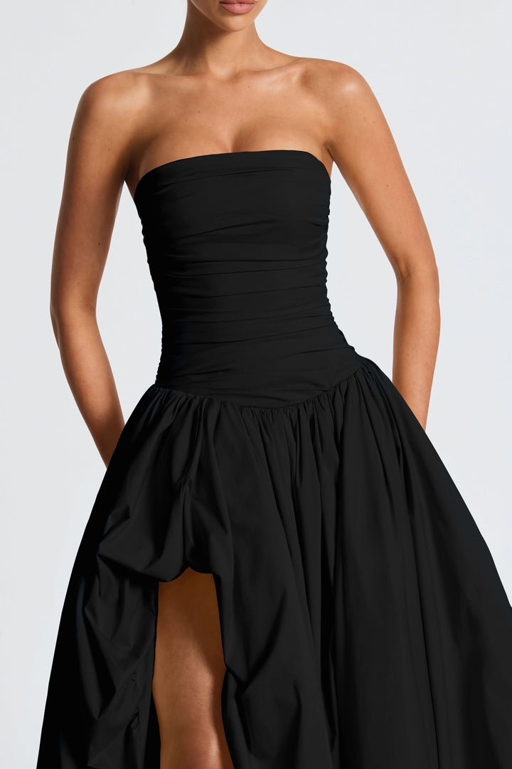 Close-up of black strapless ruched bodice with high-low maxi skirt