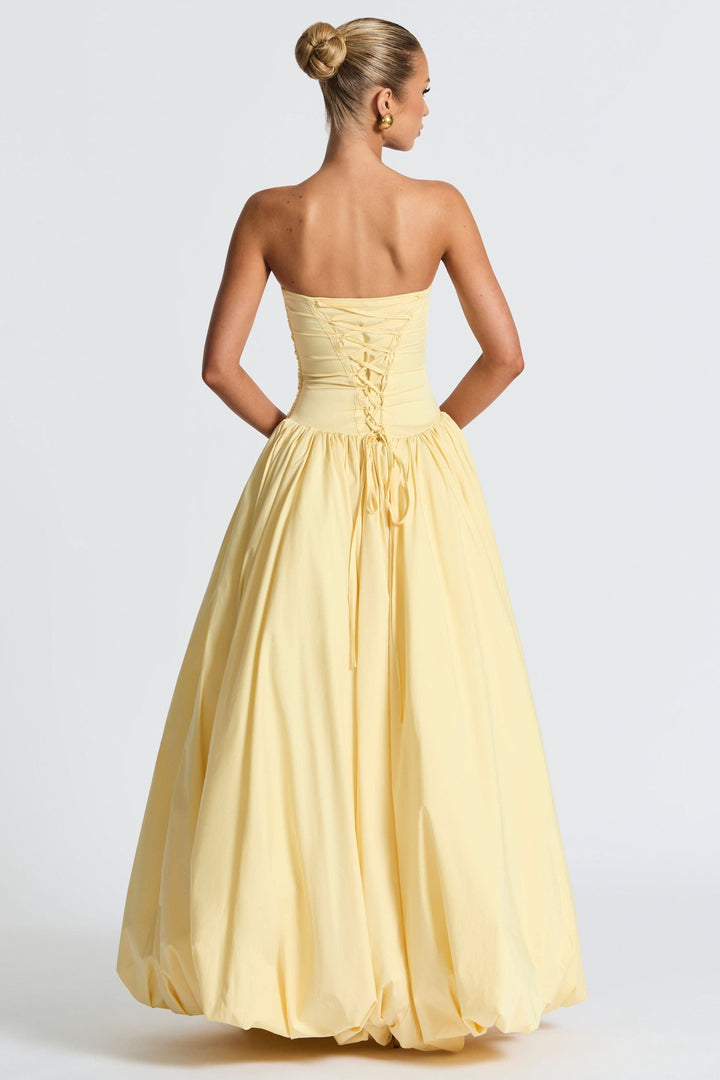 Back view of yellow strapless dress showing lace-up corset detail