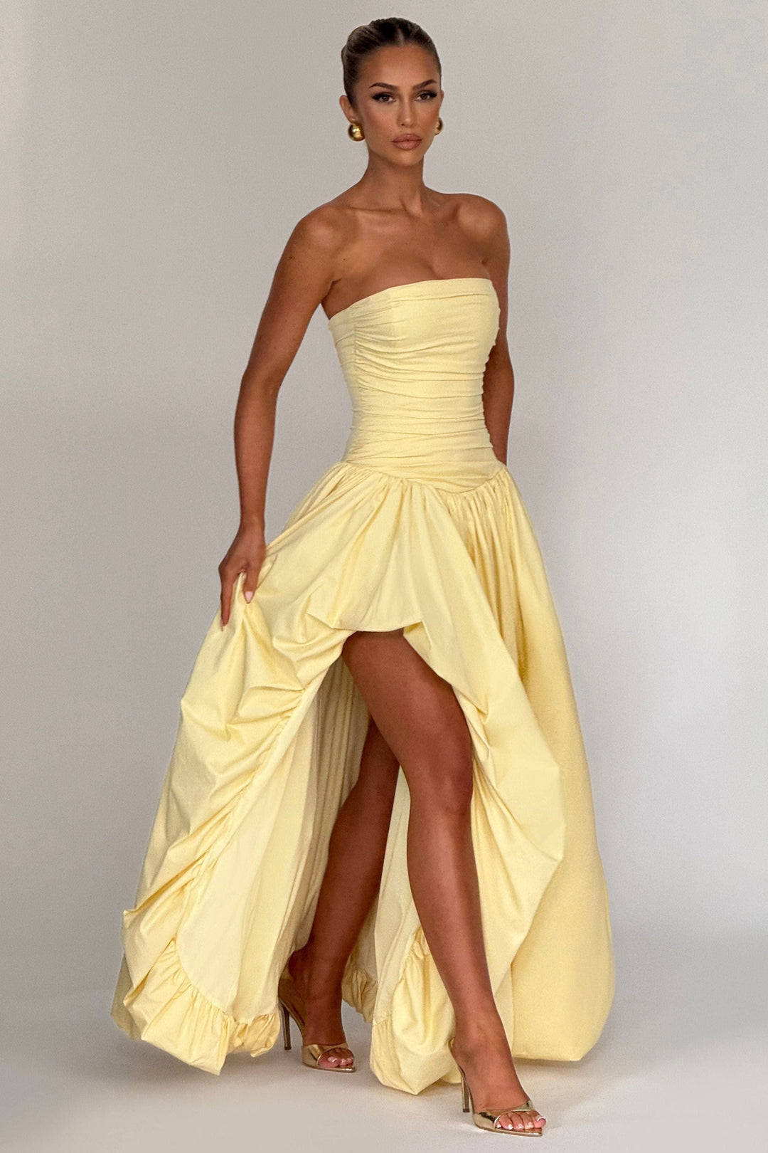 Front view yellow high-low maxi dress with ruched strapless neckline
