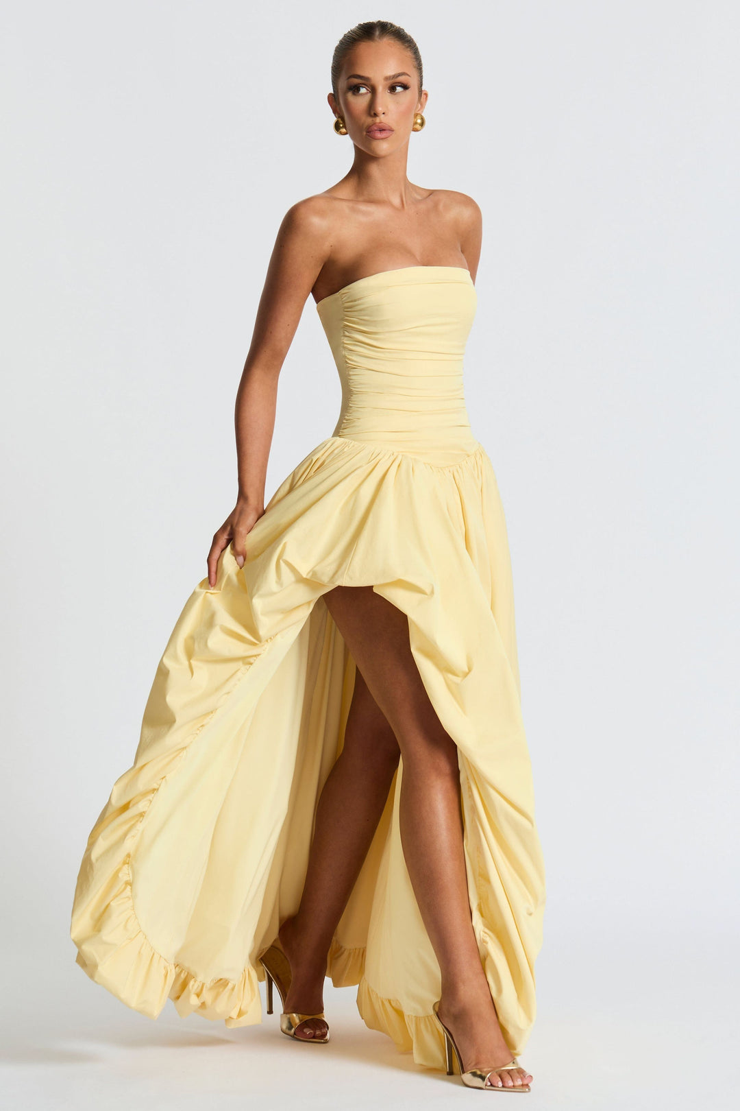 Strapless yellow dress with ruched waist and asymmetrical high-low skirt