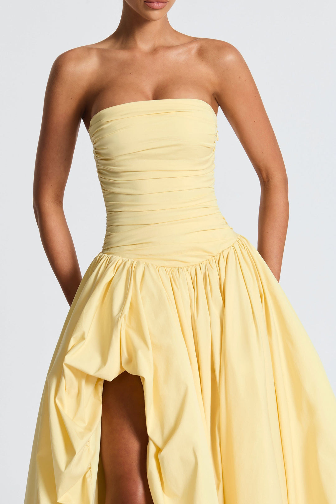 Close-up of yellow strapless dress bodice with horizontal ruching detail