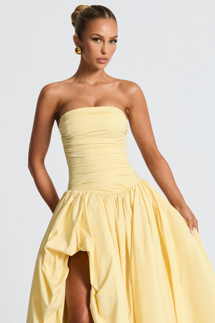 Yellow strapless maxi dress with ruched waist and voluminous high-low skirt