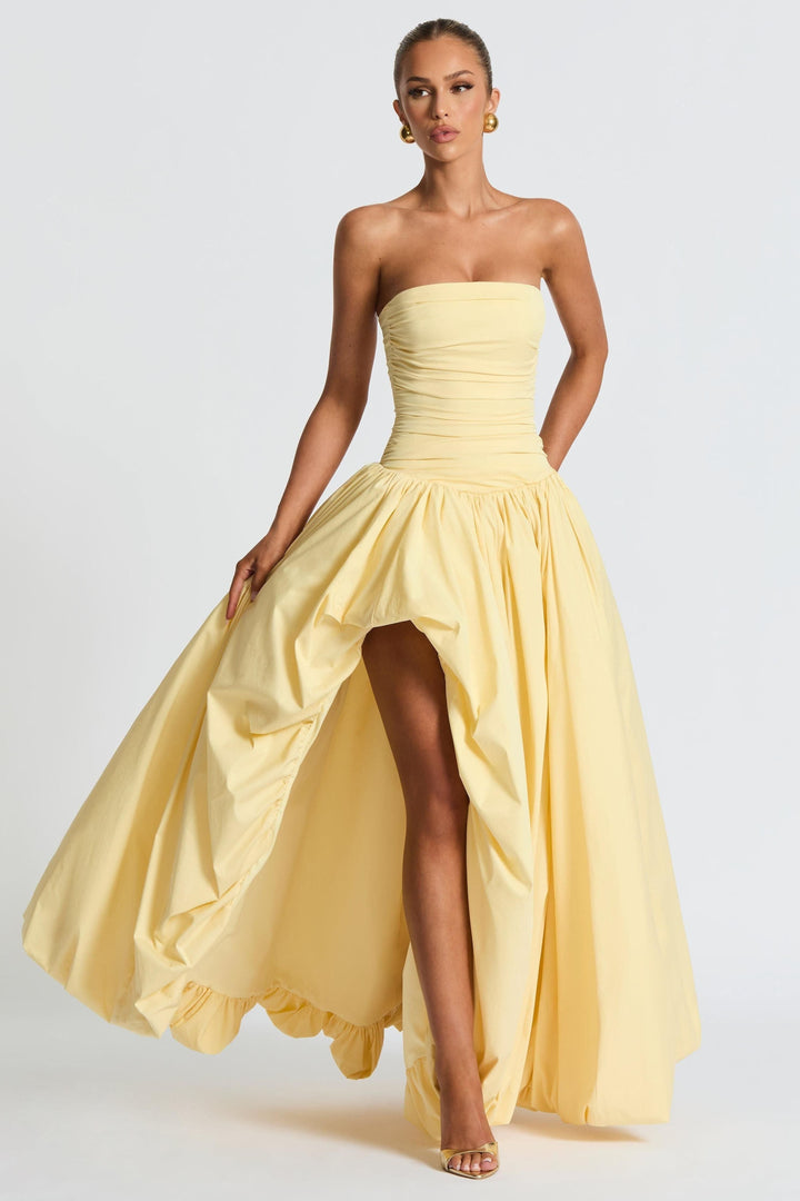 Strapless yellow high-low maxi dress with ruched bodice and flowing skirt