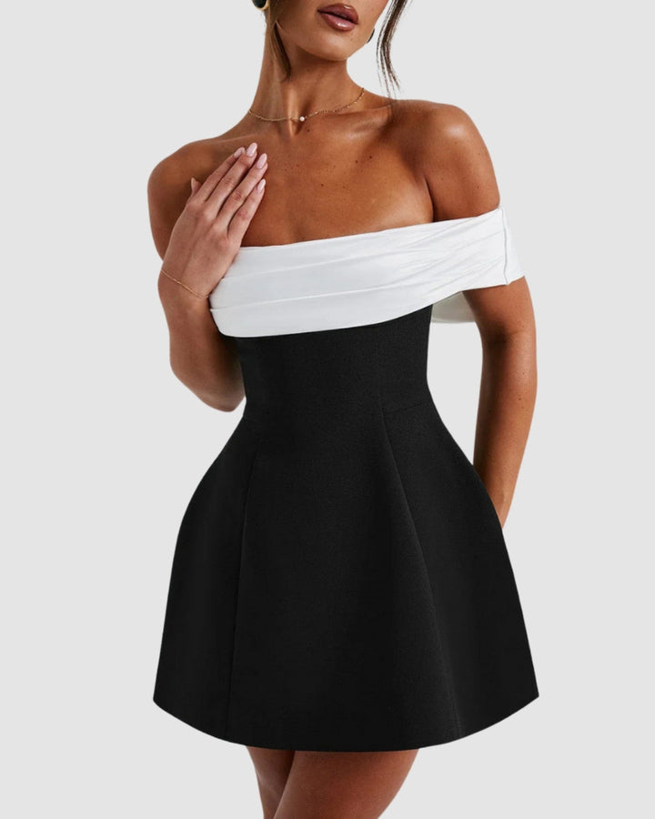 Close-up of off-shoulder Bardot neckline on black and white mini dress