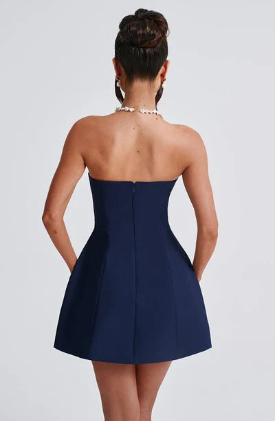 Back view of navy strapless bubble mini dress with seamed bodice