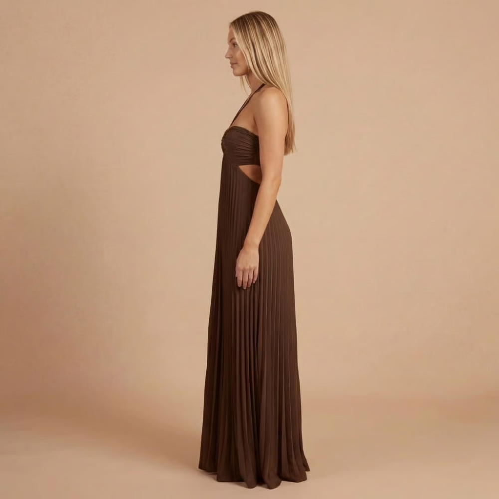 Side profile of brown halter maxi dress with pleated skirt and cutout