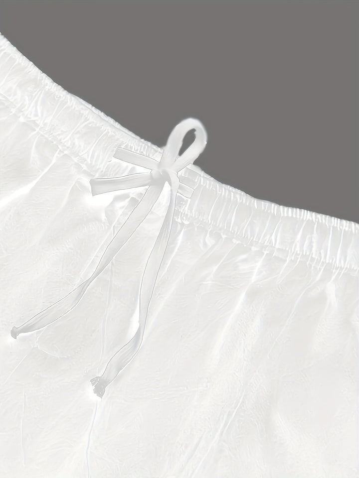 Close-up of white swim shorts drawstring and waistband detail, men bathing suit fabric