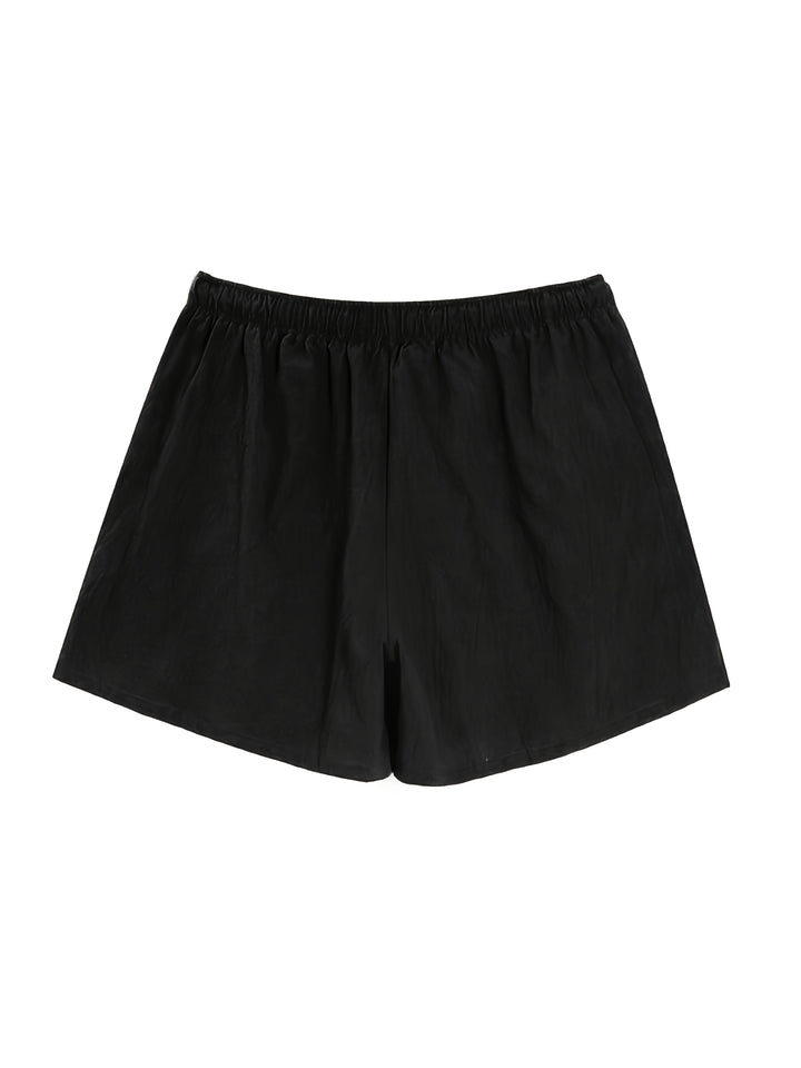 Black swim shorts laid flat, front view with elastic waist and drawstring, men bathing suit
