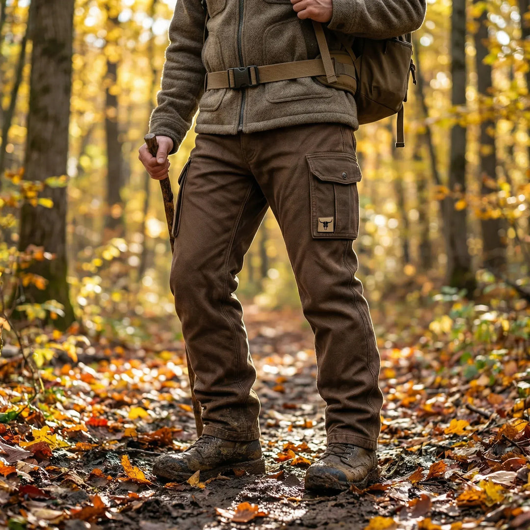 Brown cargo pants with belt worn outdoors, straight fit and multiple utility pockets