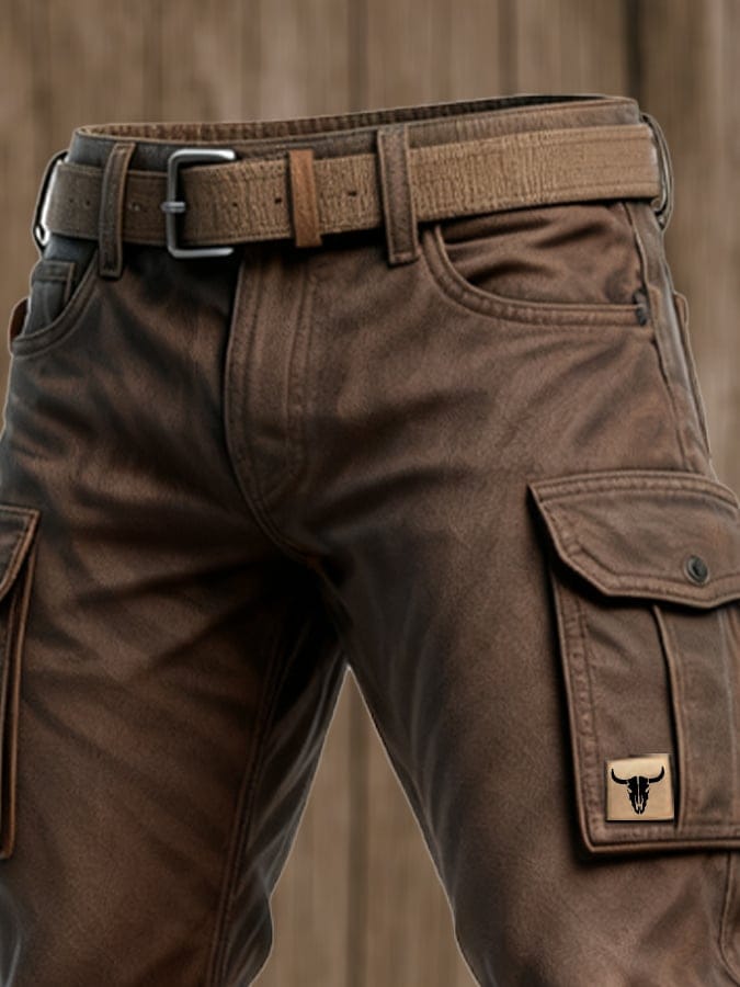 Front view of brown cargo pants with belt, relaxed fit and side cargo pocket on wood background