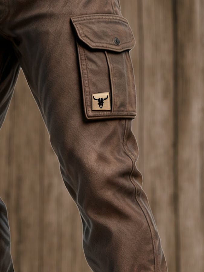 Side close-up of brown cargo pants with belt, flap cargo pocket and tapered leg detail