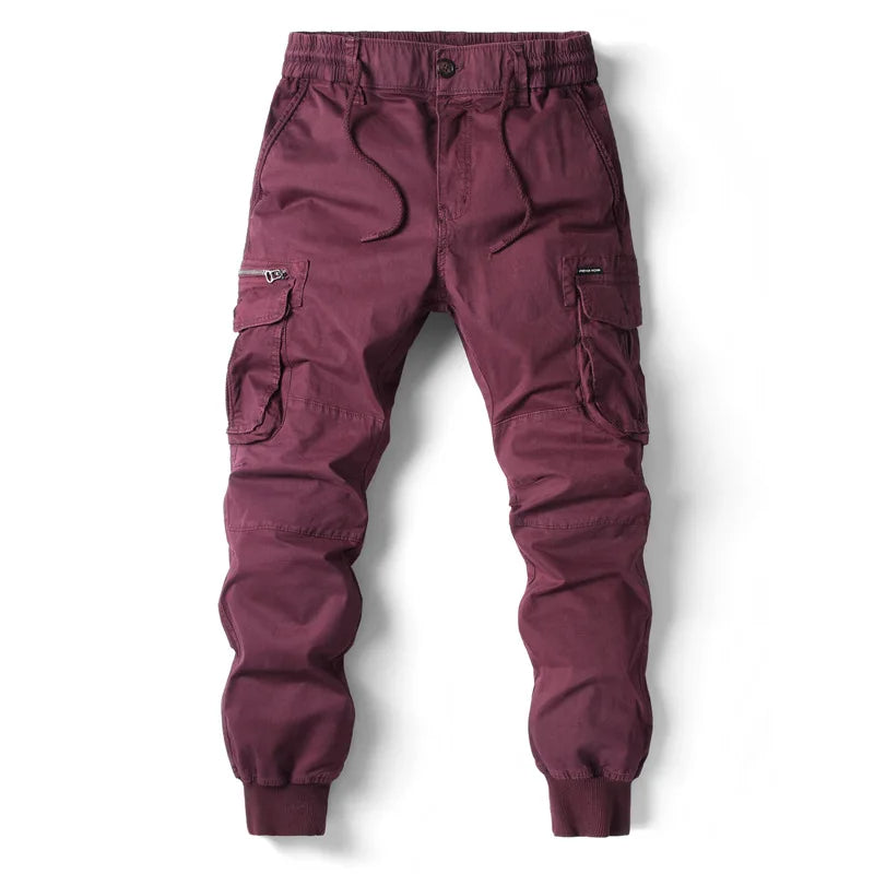 Maroon cargo jogger pants for men shown front view with zip pockets and cuffed ankles