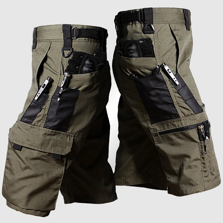Olive green men cargo knee length shorts with black panel cargo pockets, zipper trim, and utility loop belt