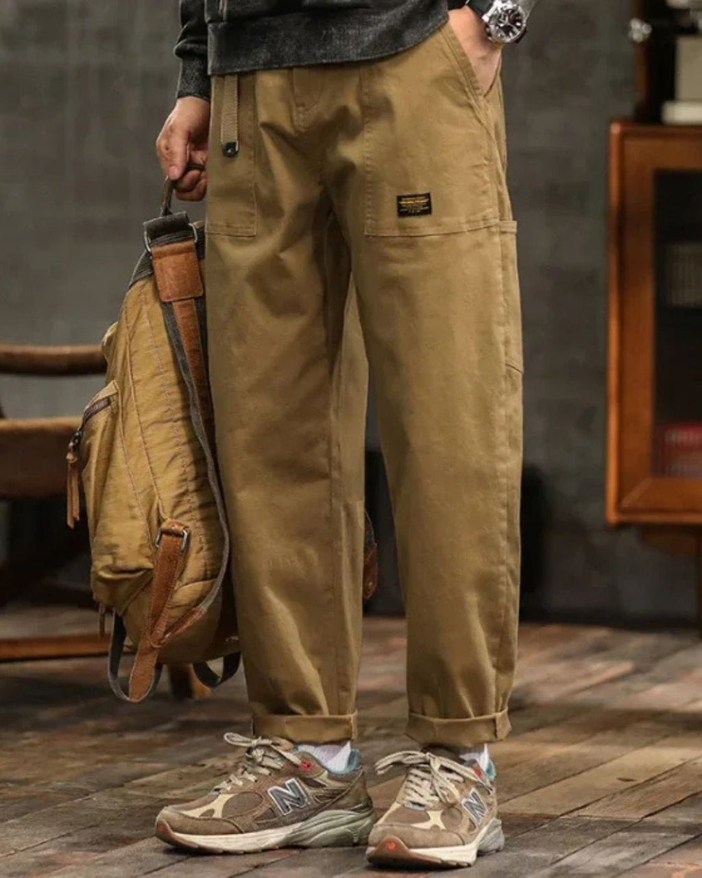 Khaki cargo pants with relaxed straight leg, side pocket detail, and rolled cuffs