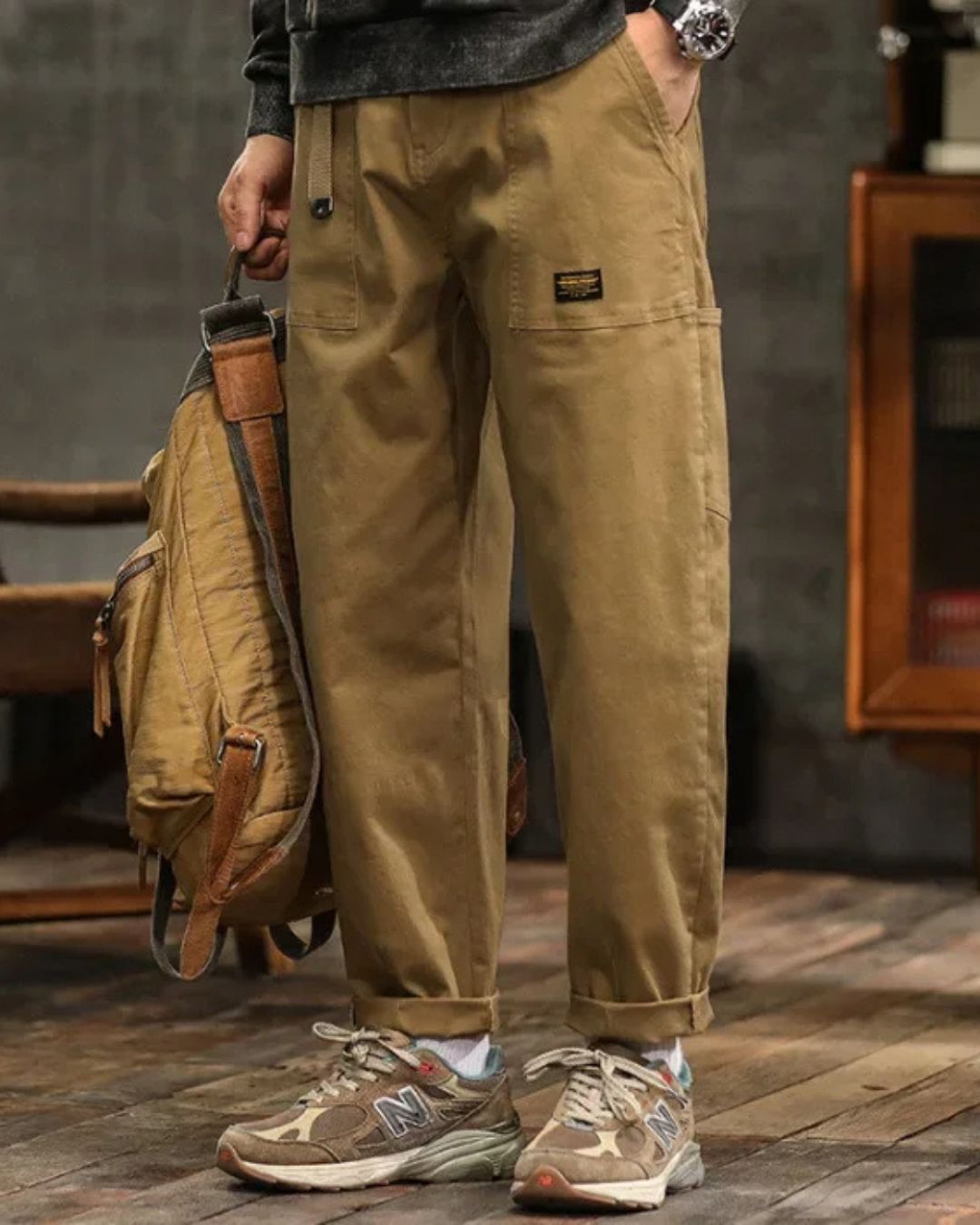 Khaki cargo pants with relaxed straight leg, side pocket detail, and rolled cuffs