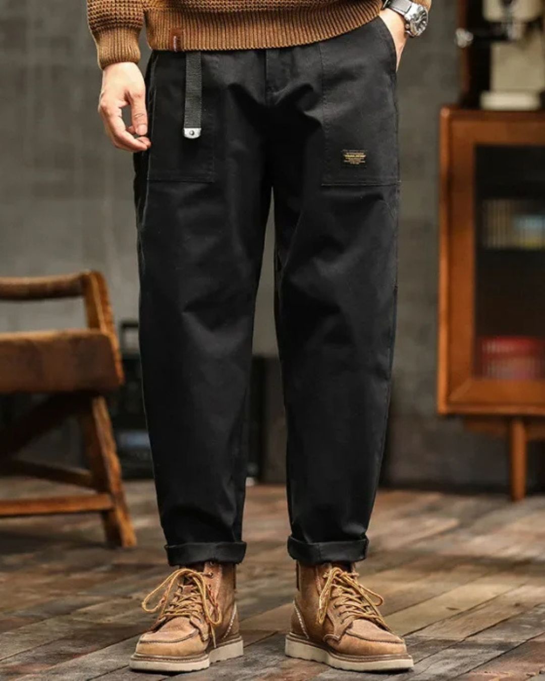 Navy cargo pants with relaxed straight leg, cuffed hems, and tan lace-up boots