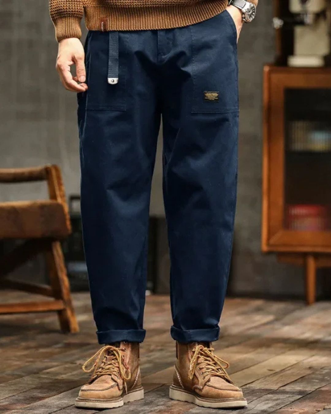 Beige cargo pants with straight leg workwear style, rolled cuffs, and casual sneakers