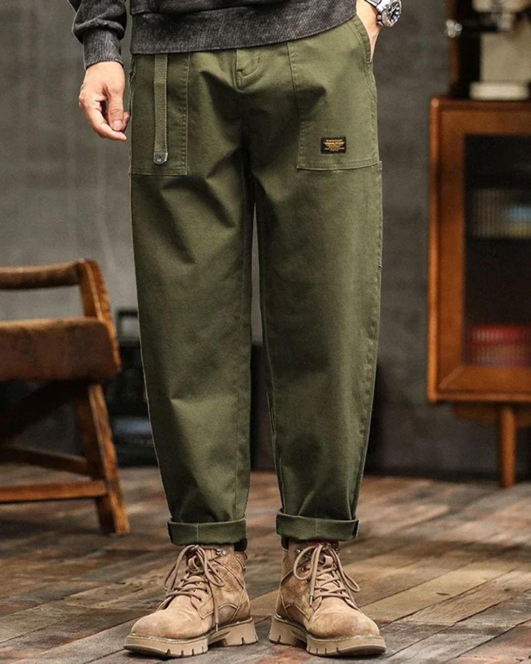 Olive green cargo pants with relaxed straight leg, cuffed hems, and tan work boots