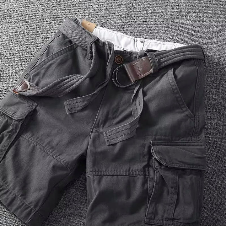 Close-up of dark gray men cargo shorts with belt, multi pocket casual details and buckle hardware