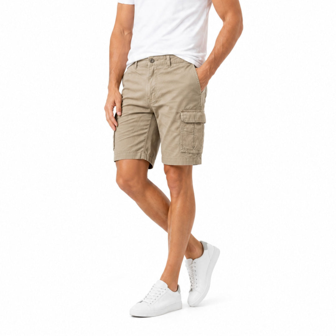 Beige men cargo shorts with pockets, front view on model in white sneakers