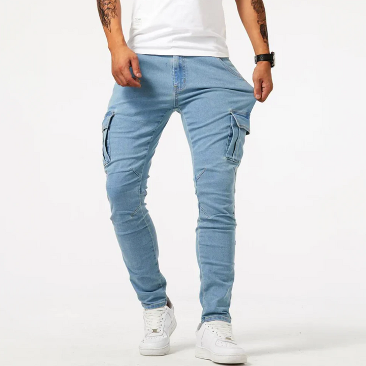 Light blue cargo skinny jeans with side pockets, front view on male model in white sneakers