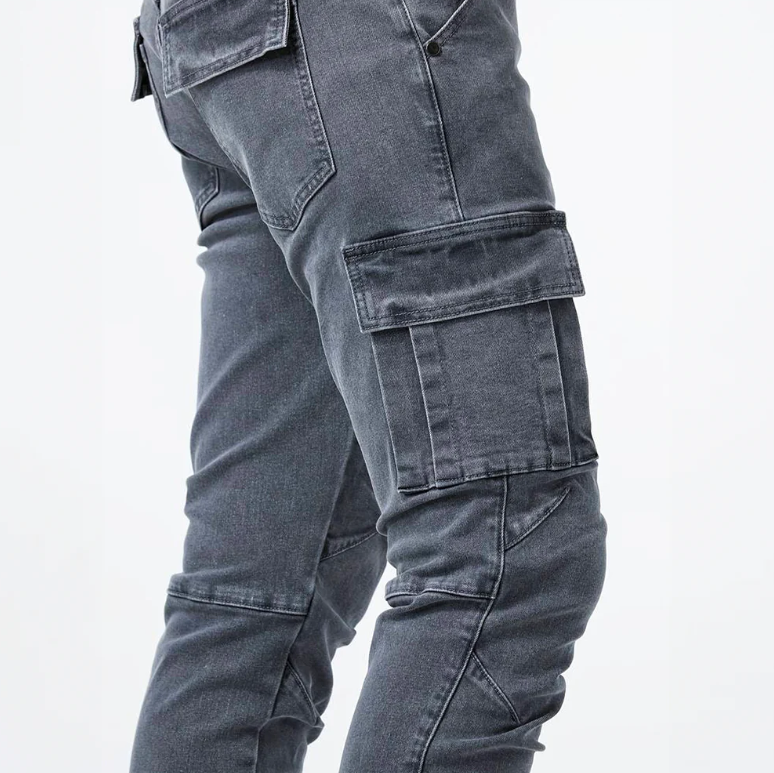 Close-up side view of gray cargo skinny jeans showing flap side pockets and stitched seams