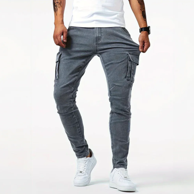 Front view of gray cargo skinny jeans with side pockets and tapered fit on male model