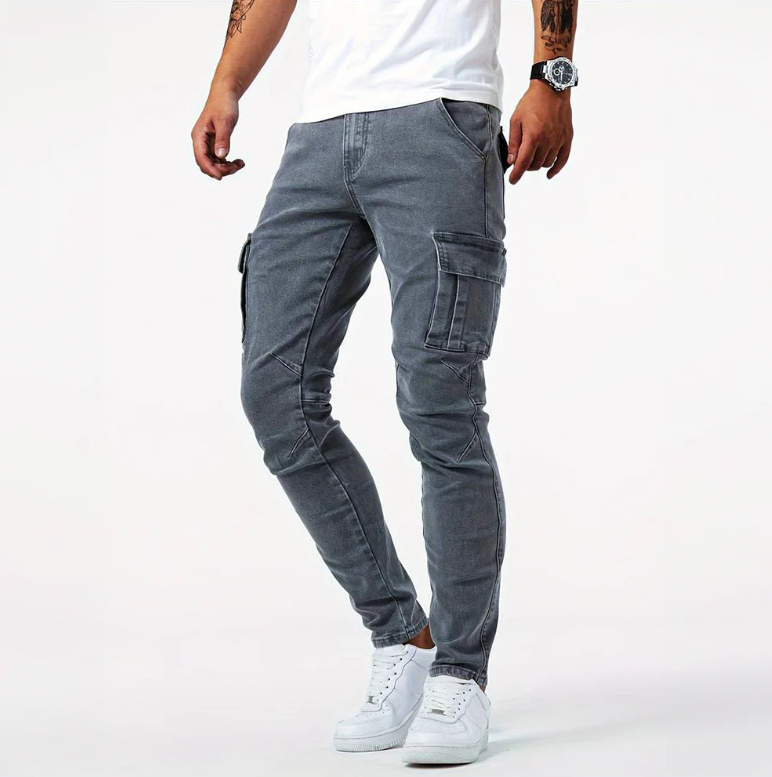 Gray cargo skinny jeans with side pockets, front view on male model with white sneakers