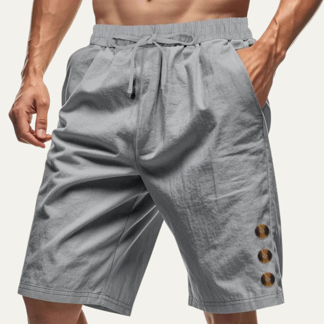 Gray men casual drawstring shorts with button detail and relaxed fit on model