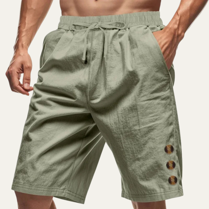 Olive green men casual shorts with drawstring waist and side button detail on model
