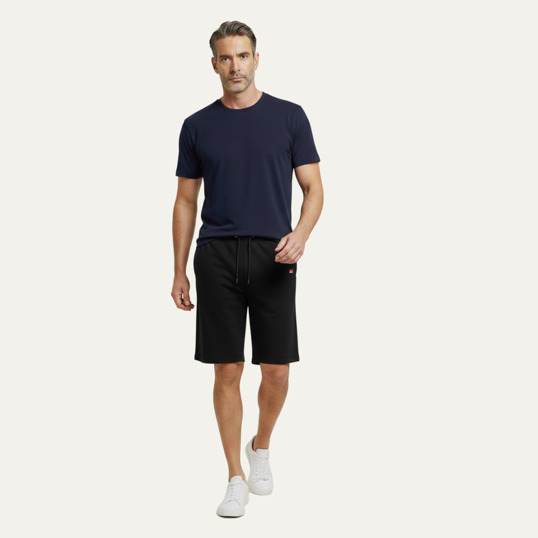 Model wearing black jogger shorts with drawstring and side pockets