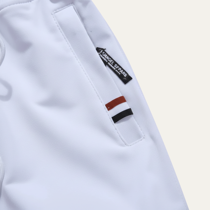 Close-up of white casual shorts pocket with zipper and side logo tag