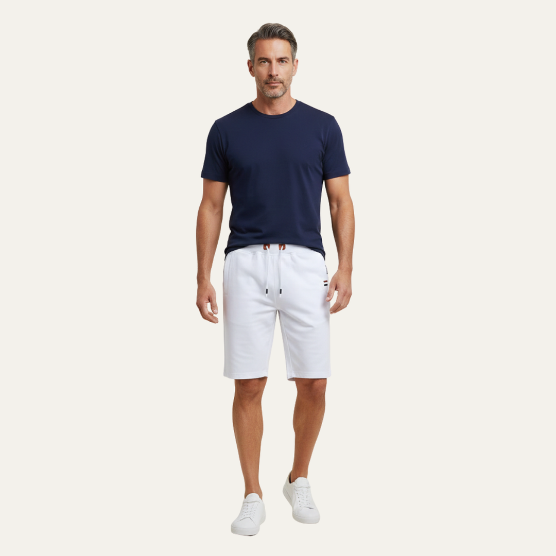 Model wearing white jogger shorts with drawstring waist and knee-length fit