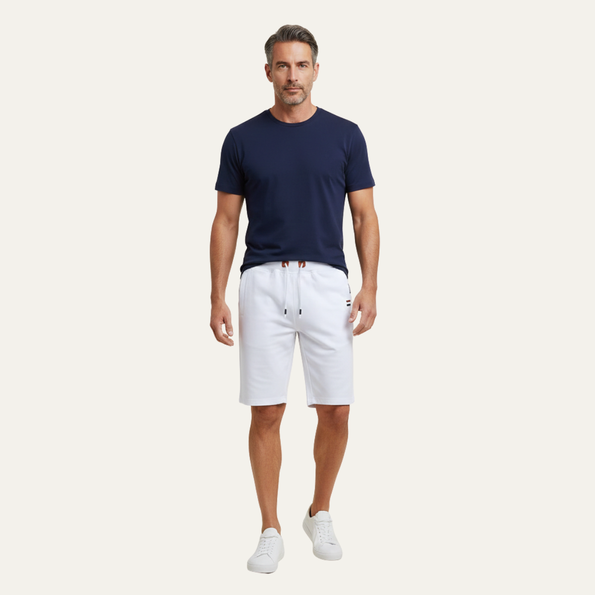 Model wearing white jogger shorts with drawstring waist and knee-length fit
