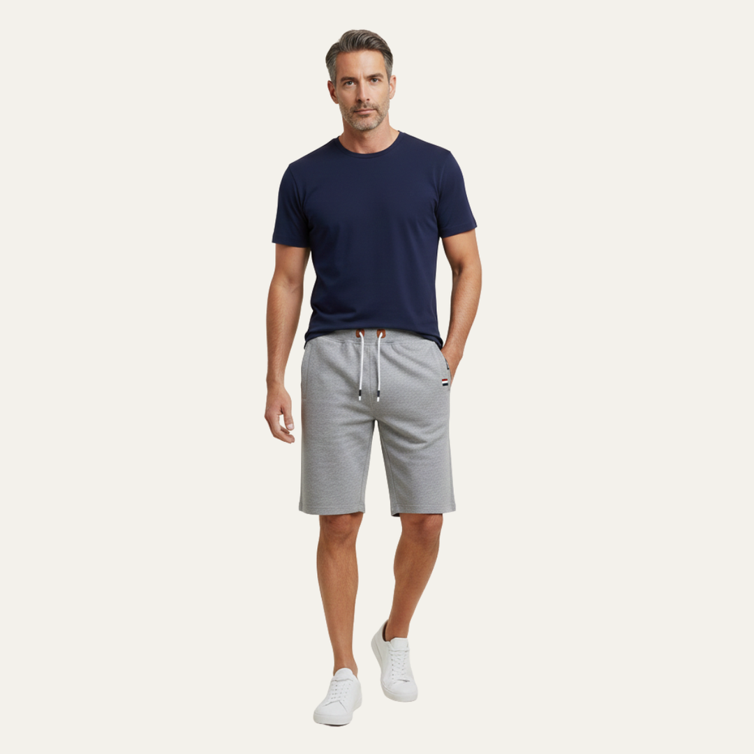 Model wearing light gray casual shorts with drawstring waist and relaxed fit